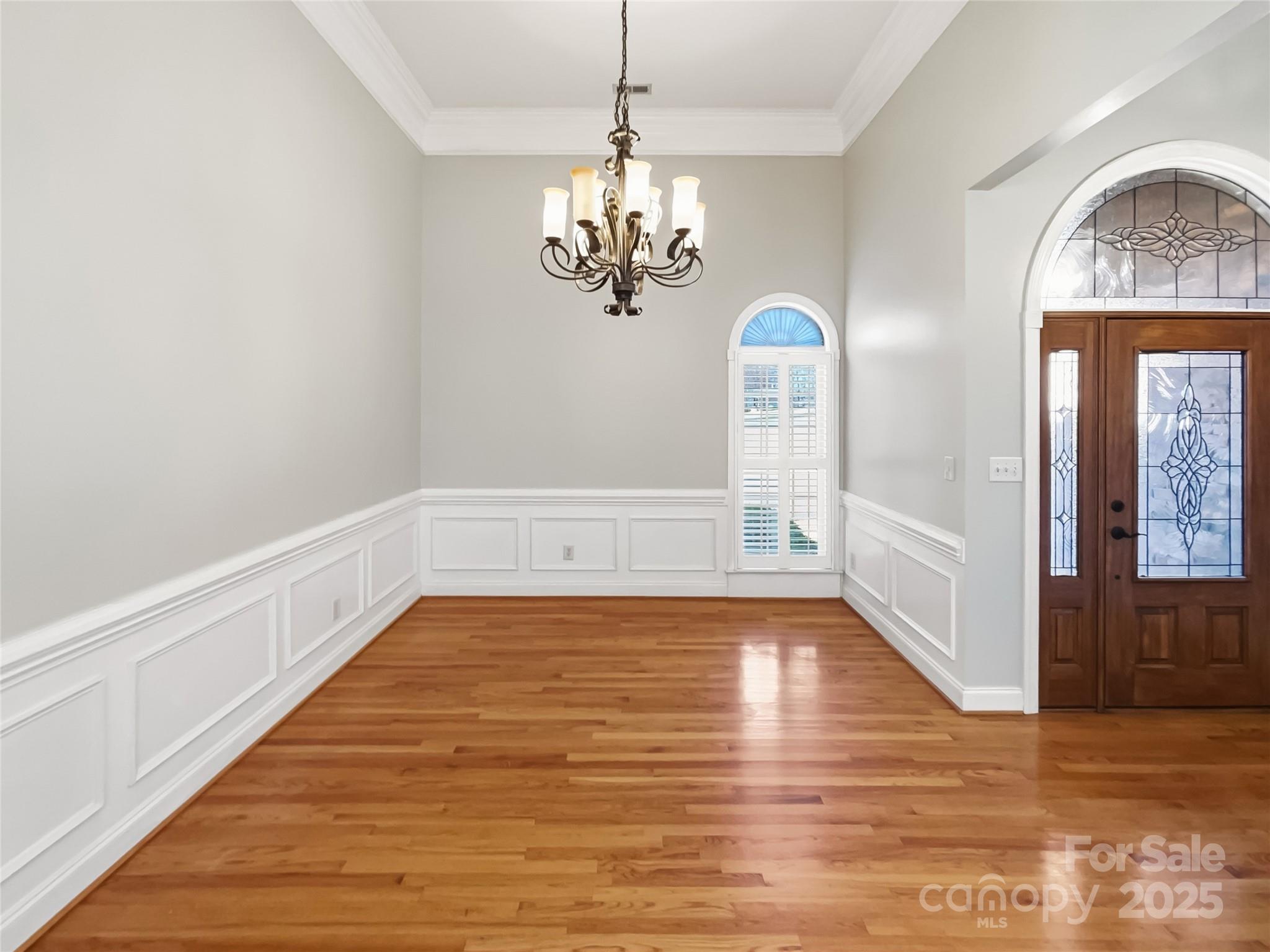 924 Ferguson Ridge Road Gastonia, NC 28052 - Photo 9 of 23 a view of an empty room with chandelier and wooden floor