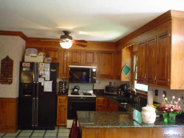 15004 Walnut Bend Road Midlothian, VA 23112 - Photo 4 of 10 a kitchen with a refrigerator and a stove top oven