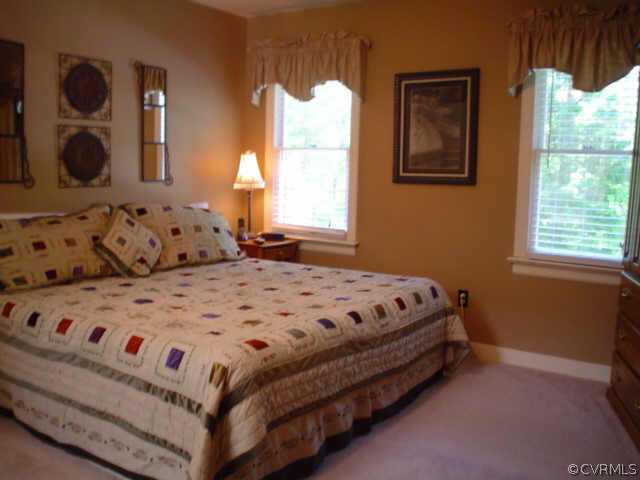 15004 Walnut Bend Road Midlothian, VA 23112 - Photo 7 of 10 a bedroom with a bed and large windows