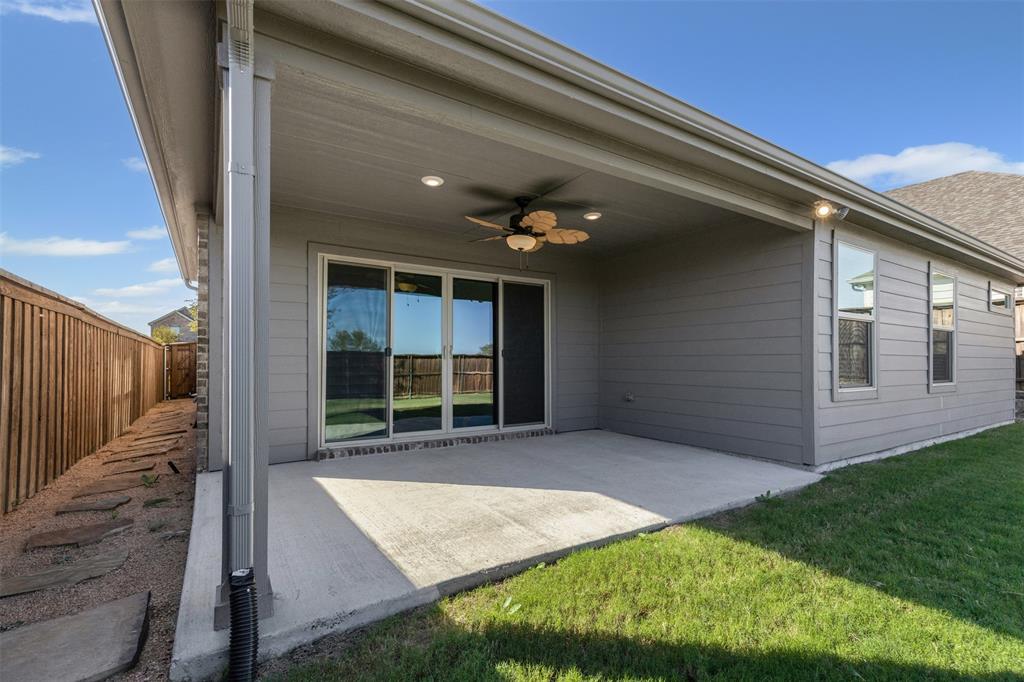 10508 Brookshire Road Fort Worth, TX 76126 - Photo 23 of 31 Rear view of house with ceiling fan, a patio area, roof with shingles, and a fenced backyard