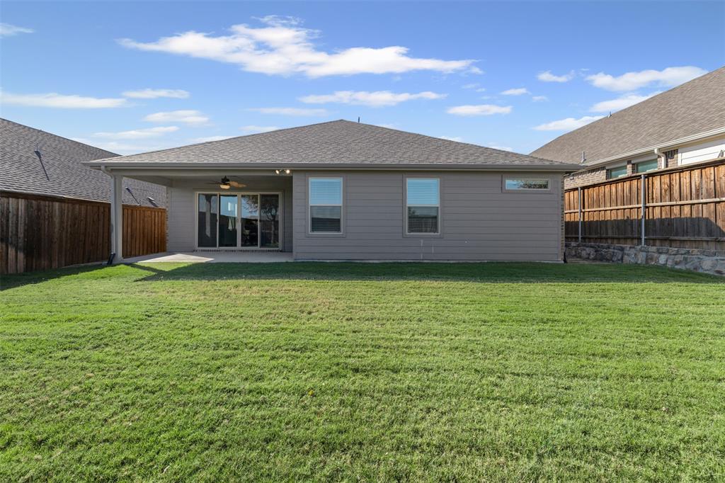 10508 Brookshire Road Fort Worth, TX 76126 - Photo 25 of 31 Rear view of property featuring a fenced backyard, a patio area, roof with shingles, and a ceiling fan
