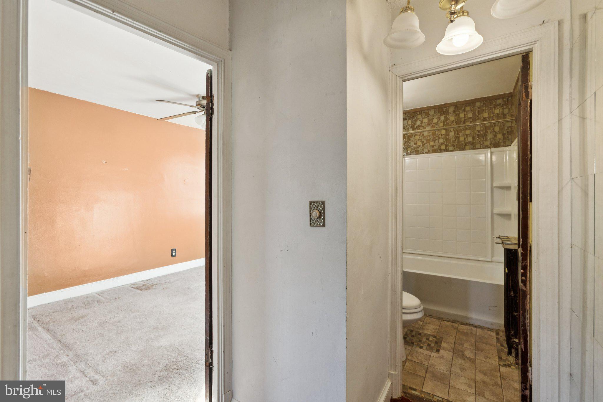 1633 R Street Southeast Washington, DC 20020 - Photo 19 of 44 a bathroom with a glass shower door and a toilet