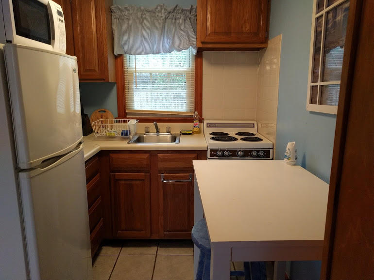 49 Lower County Road, Unit 15 Dennis Port, MA 02639 - Photo 3 of 7 a kitchen with a refrigerator a stove a sink a washer dryer and a window