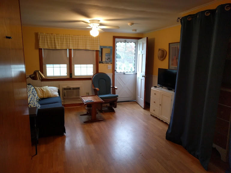 49 Lower County Road, Unit 15 Dennis Port, MA 02639 - Photo 5 of 7 a living room with furniture and a fireplace