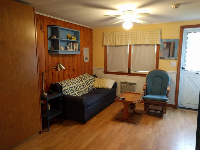 49 Lower County Road, Unit 15 Dennis Port, MA 02639 - Photo 6 of 7 a living room with furniture and a chair