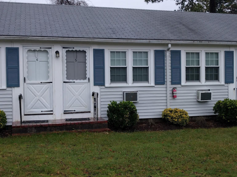 49 Lower County Road, Unit 15 Dennis Port, MA 02639 - Photo 7 of 7 a front view of a house with garden