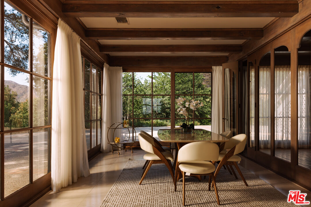3100 Mandeville Canyon Road Los Angeles, CA 90049 - Photo 11 of 23 a dining room with furniture and window