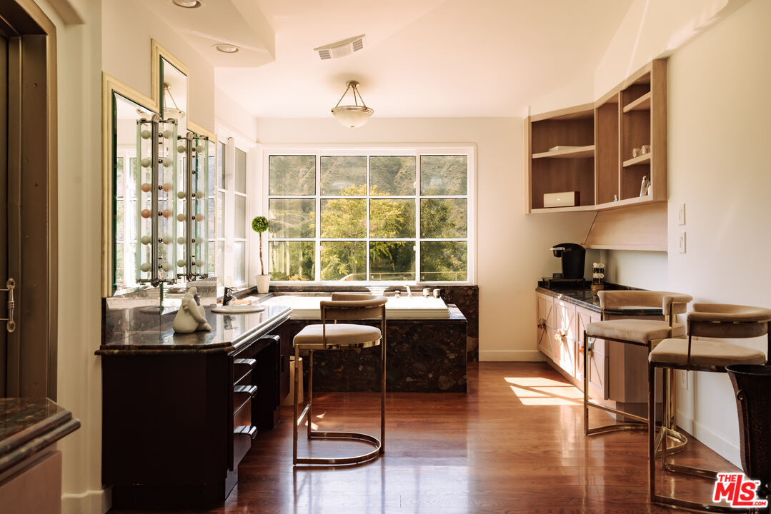 3100 Mandeville Canyon Road Los Angeles, CA 90049 - Photo 14 of 23 a kitchen with granite countertop a sink and a stove