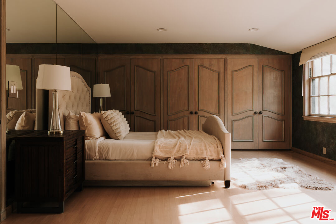 3100 Mandeville Canyon Road Los Angeles, CA 90049 - Photo 15 of 23 a bedroom with a bed and a night stand