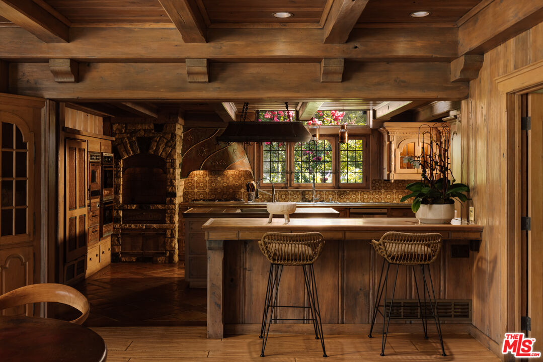 3100 Mandeville Canyon Road Los Angeles, CA 90049 - Photo 8 of 23 a kitchen with stainless steel appliances granite countertop a sink and cabinets