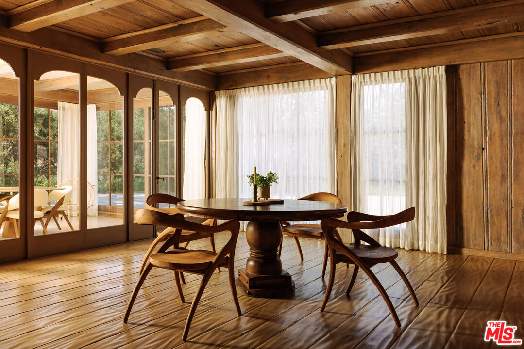 3100 Mandeville Canyon Road Los Angeles, CA 90049 - Photo 9 of 23 a view of a dining room with furniture and wooden floor