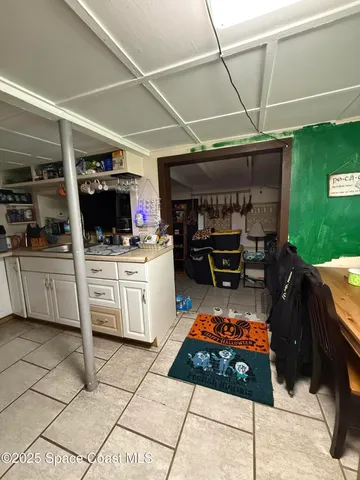 a kitchen with a stove a sink and a cabinets