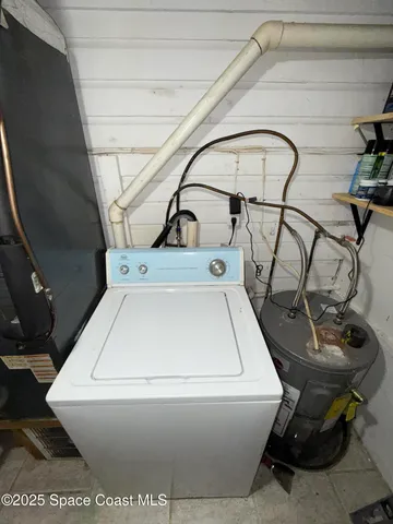 a utility room with dryer washer and other items