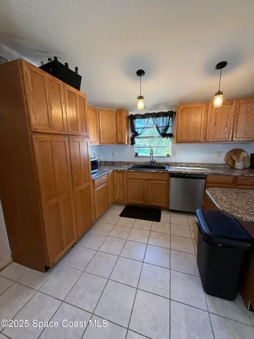 a kitchen with stainless steel appliances granite countertop a sink counter space and cabinets