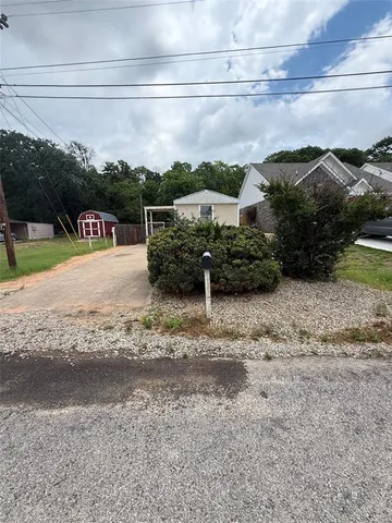 a view of a street with a car parked on the road
