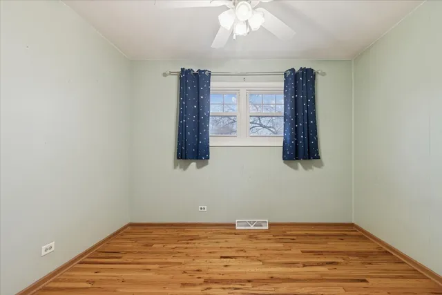 a view of a room with wooden floor and chandelier