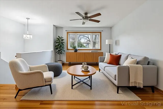 a living room with furniture a window and a potted plant