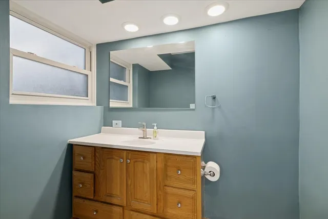 a bathroom with a sink vanity and mirror