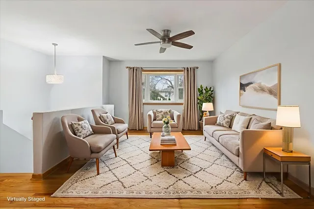 a living room with furniture a rug and a large window