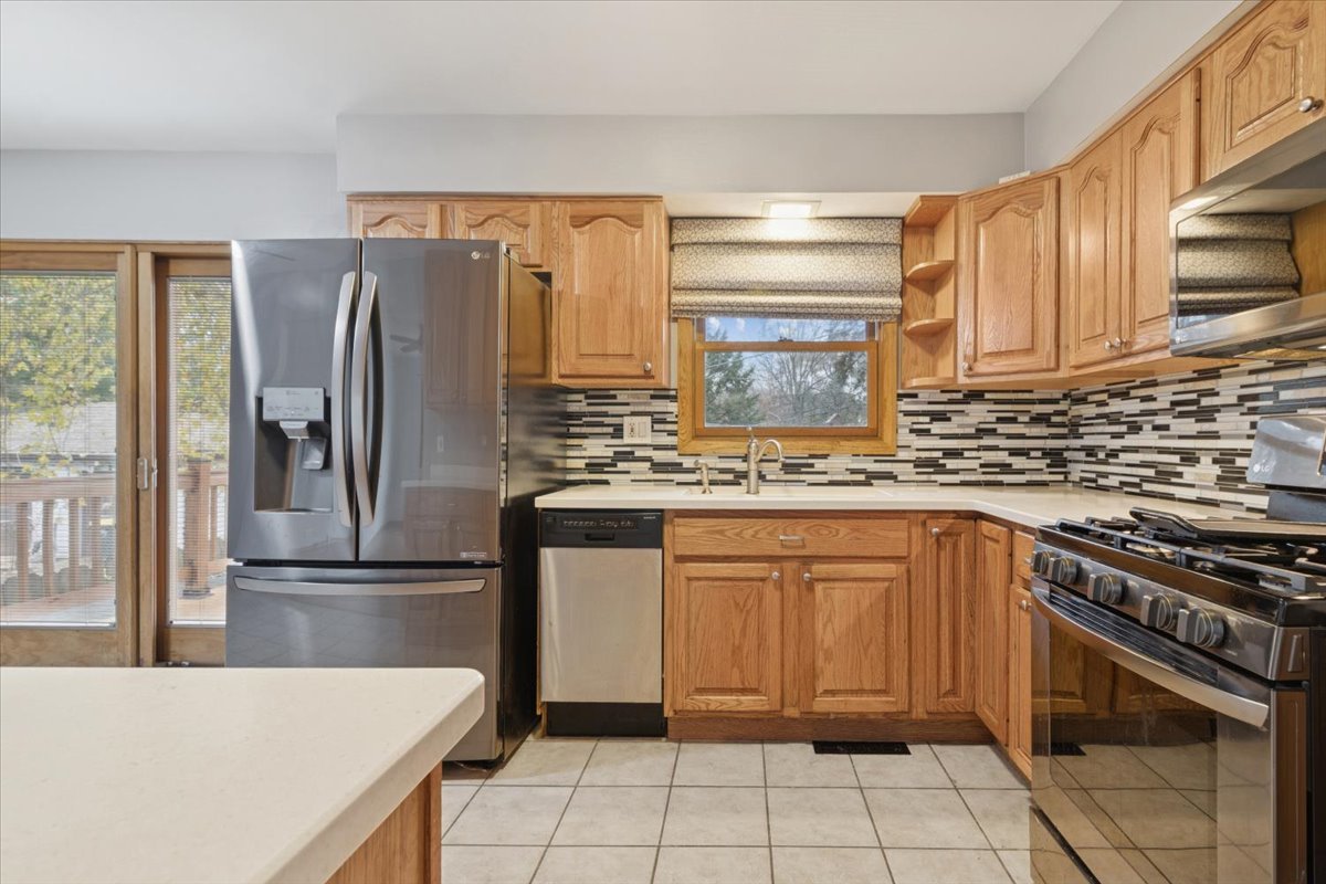 26-w028 Prairie Avenue Wheaton, IL 60187 - Photo 6 of 28 a kitchen with stainless steel appliances granite countertop a refrigerator sink and stove