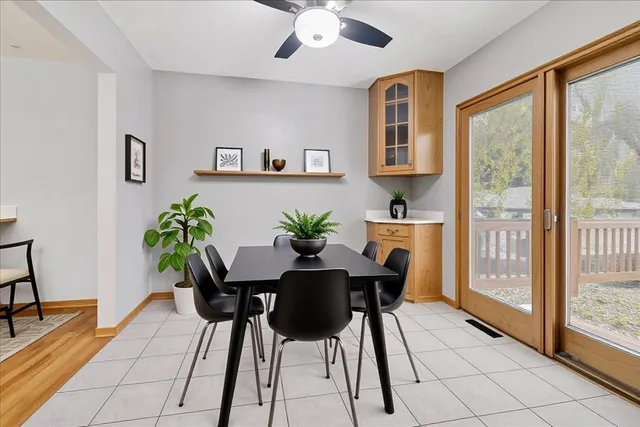 a view of a dining room with furniture and a potted plant