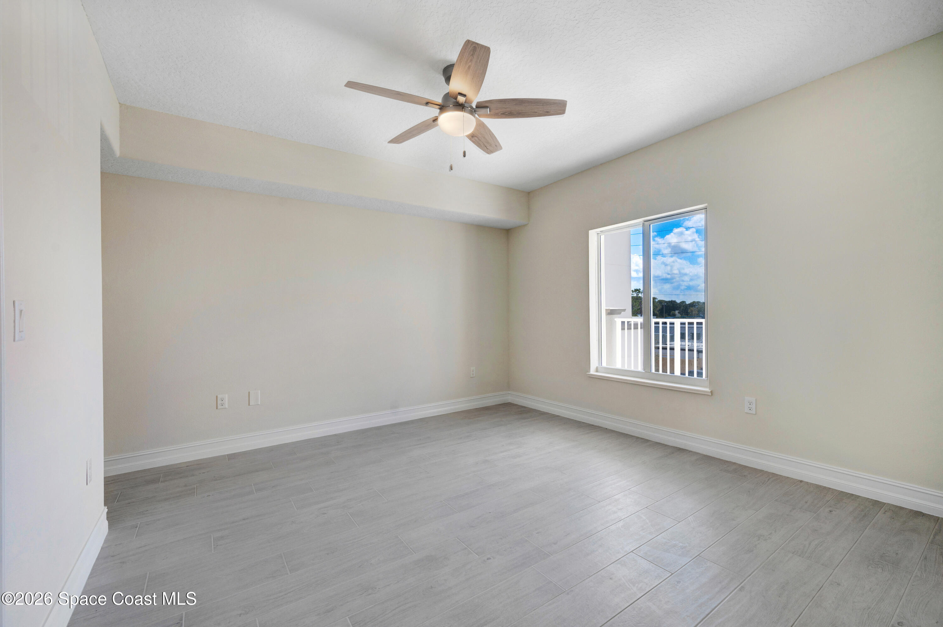 1805 Riverside Drive, Unit 304 Titusville, FL 32780 - Photo 16 of 46 an empty room with window and ceiling fan