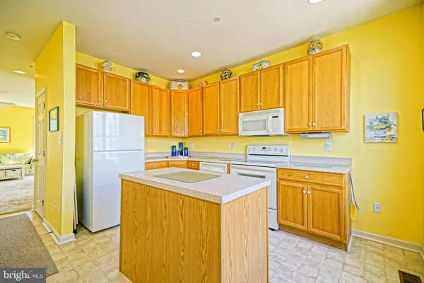 a kitchen with a sink a refrigerator and cabinets