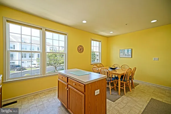 a kitchen that has a table and chairs in it