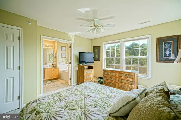 a bedroom with a bed and a television