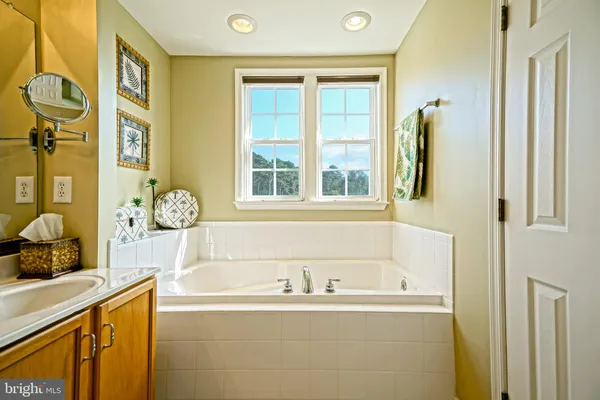 a bathroom with a granite countertop toilet and a sink