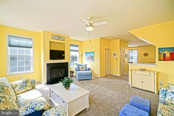 a living room with furniture fireplace and a flat screen tv