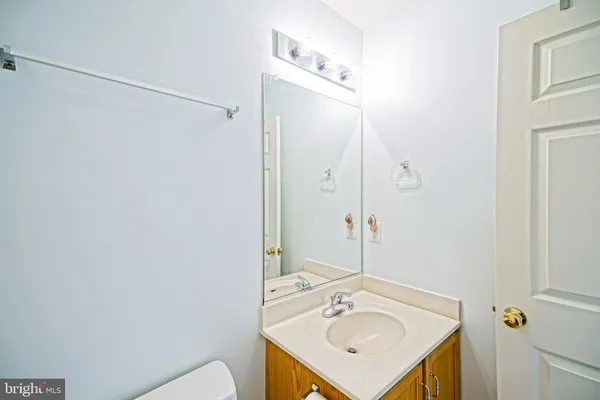 a bedroom with a bed and a flat tv screen on dresser