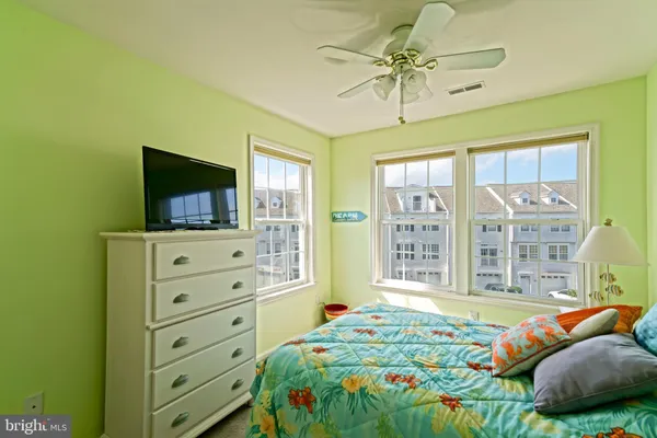 a bedroom with a bed and a television