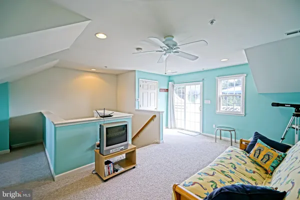 a bedroom with a bed and a chair in it