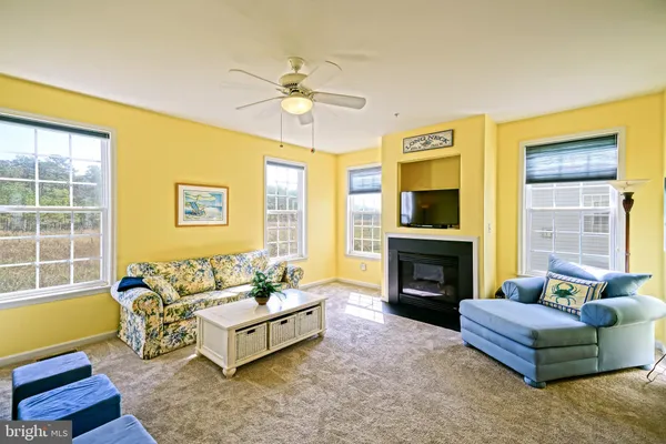 a living room with furniture fireplace and a flat screen tv