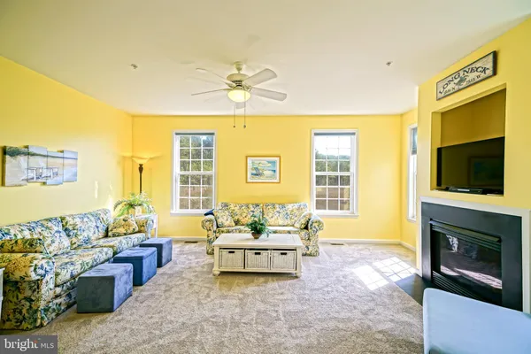 a living room with furniture fireplace and flat screen tv