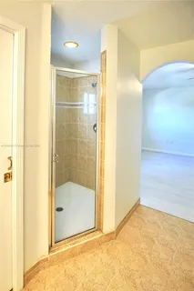 a bathroom with a glass shower door and a bathroom