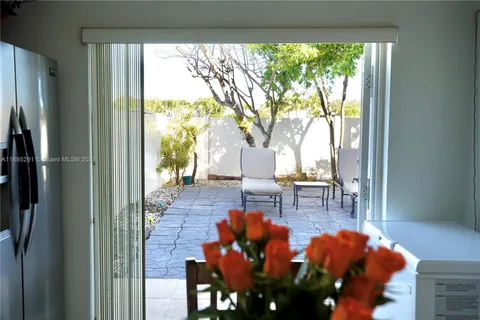 a living room filled with furniture and a large window