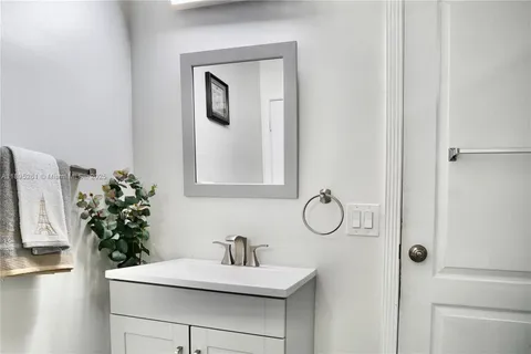 a bathroom with a sink vanity and mirror