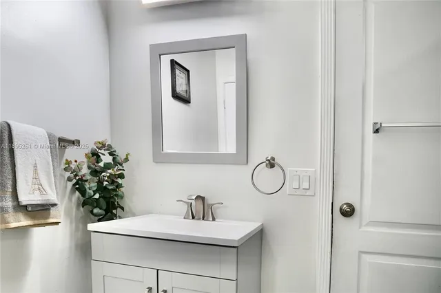 a bathroom with a sink vanity and mirror