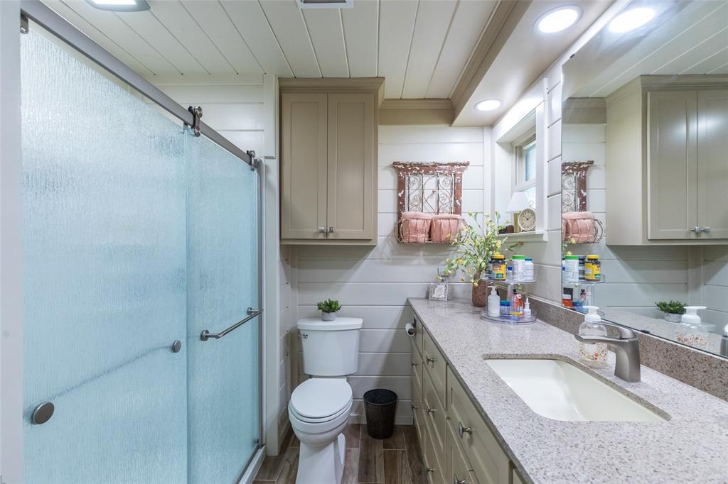 304 South Ave H Avenue Haskell, TX 79521 - Photo 21 of 38 a bathroom with a granite countertop sink toilet and shower