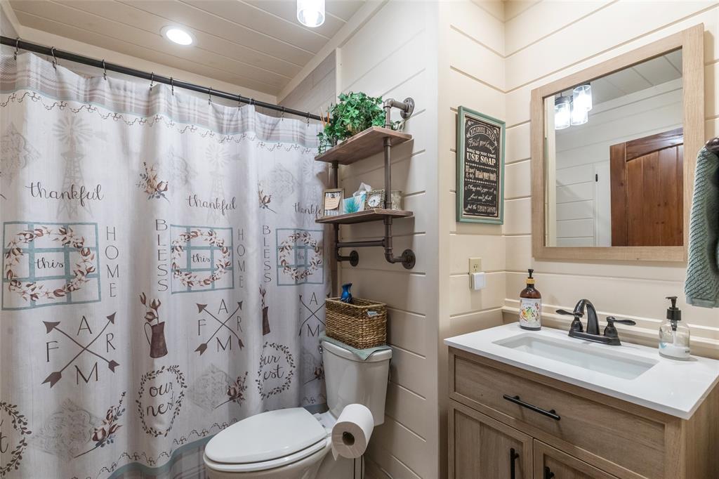 304 South Ave H Avenue Haskell, TX 79521 - Photo 24 of 38 a bathroom with a granite countertop sink toilet and shower