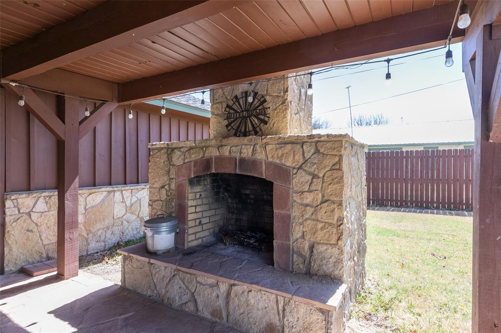 304 South Ave H Avenue Haskell, TX 79521 - Photo 28 of 38 a view of an empty room with wooden floor and a fireplace