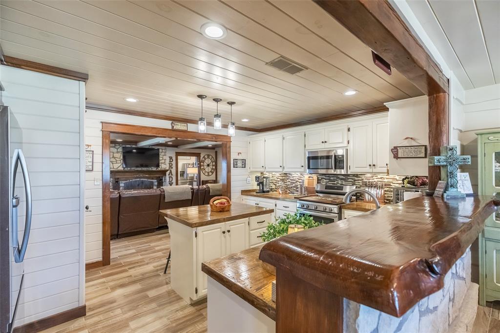 304 South Ave H Avenue Haskell, TX 79521 - Photo 7 of 38 a kitchen with lots of counter top space and stainless steel appliances