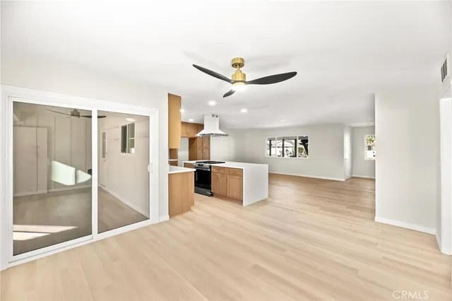 a view of a kitchen with a sink and a refrigerator