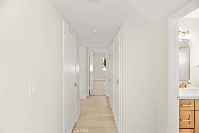 a view of a hallway with wooden shelves