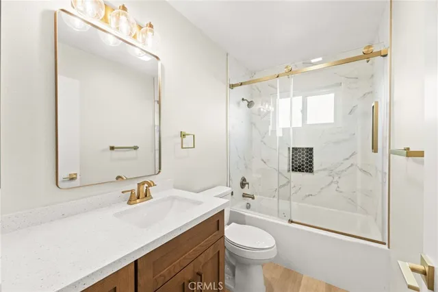 a bathroom with a sink toilet a mirror and shower