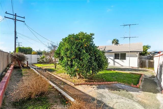 a view of a house with a yard and sitting area