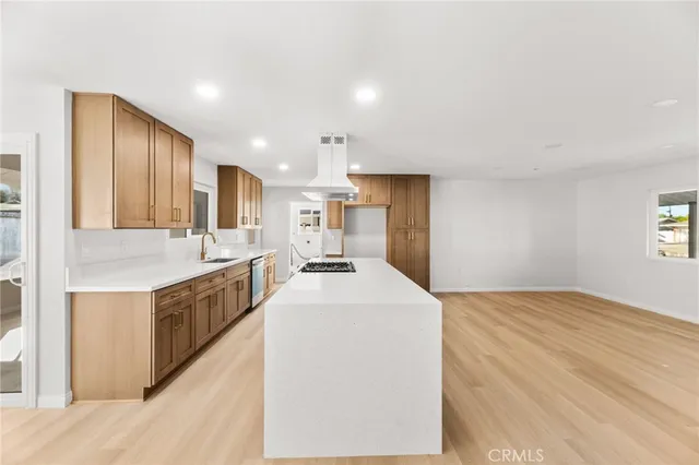 a kitchen with stainless steel appliances kitchen island a sink stove and refrigerator