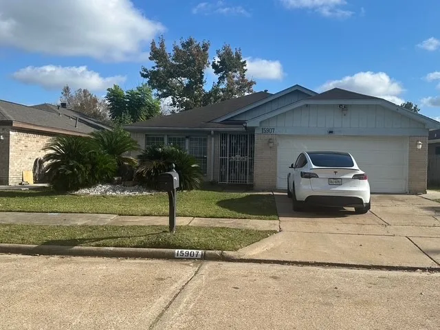 a front view of a house with a yard and potted plants